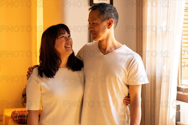 Portrait of Japanese brother and sister are hugging smiling and looking at each other. Happy siblings look after each other