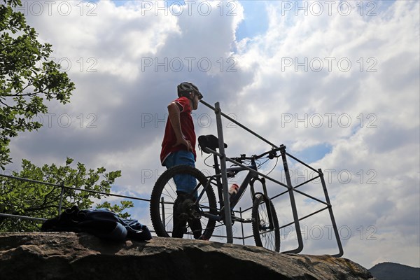 Mountain biker enjoys the view of the Palatinate Forest above Neustadt an der Weinstrasse