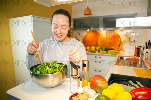 Vegan cooking: Young woman prepares lamb's lettuce