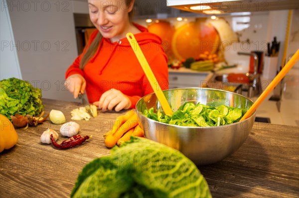 Vegan cooking: Young woman prepares lamb's lettuce