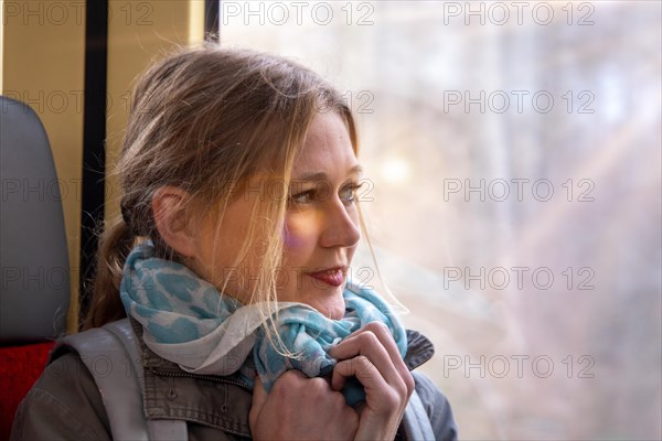 Close-up of a young woman on a train