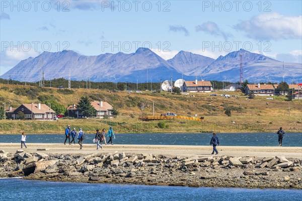 People crossing a land bridge in Golondrina Bay on the Beagle Channel, Ushuaia, Tierra del Fuego Island, Patagonia, Argentina, South America