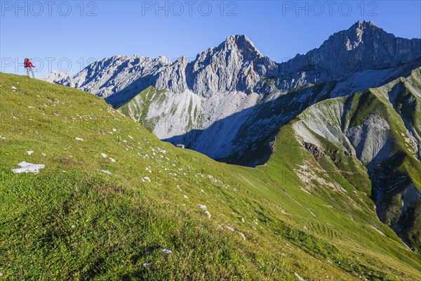 Hiker standing on ridge in front of steep mountains, woman, adult, summer, Wetterstein Mountains, Tyrol, Austria, Europe