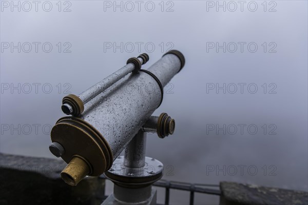 Winter atmosphere at the mountain fortress. Paying telescope with water drops, Koenigstein, Saxony, Germany, Europe