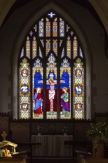 Stained glass east window in church of Saint Michael, Peasenhall, Suffolk, England, UK circa 1861 by Thomas Willement, Crucifixion of Jesus Christ