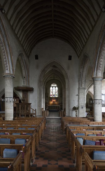 View down the nave to chancel, altar and east window inside the church at church of Saint Mary, Purton, Wiltshire, England, UK