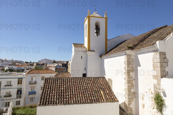 Whitewashed exterior walls and tower of Roman Catholic church Igreja de Santiago, Tavira, Algarve, Portugal, southern Europe, Europe