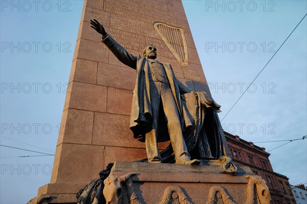 A statue to Charles St. Parnell with the harp symbol and quotation in the city centre. Dublin, Ireland, Europe