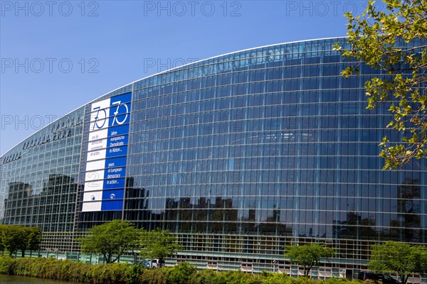 The back of the European Parliament in Strasbourg On the glass facade you can see a huge banner with the inscription 70 years of European democracy in action in French, German and English