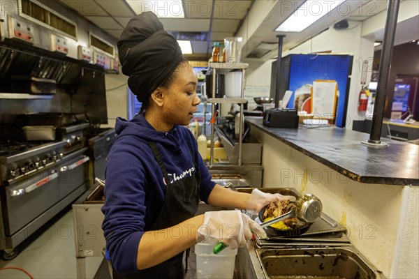Detroit, Michigan, Natasha Coleman prepares food at Yum Village restaurant, which serves Afro-Caribbean meals