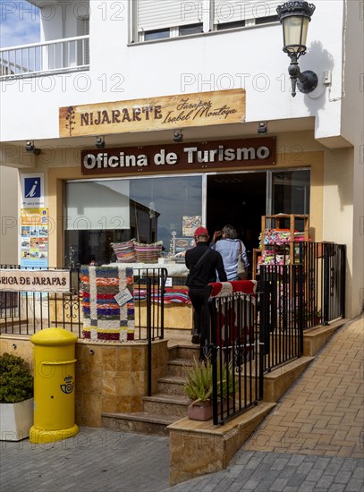 People entering the Oficina de Turismo tourist information shop and office, village of Nijar, Almeria, Spain, Europe