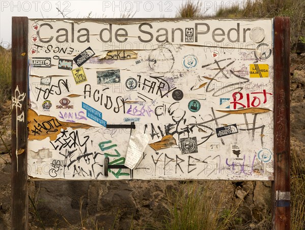 Hippy graffiti painted on noticeboard, abandoned village of Cala de San Pedro, Cabo de Gata Natural Park, Nijar, Almeria, Spain, Europe