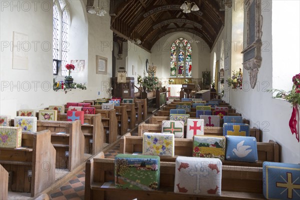 Church of Saint Peter, Blaxhall, Suffolk, England, UK pews and kneelers with Christmas decorations