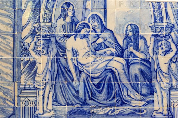 Blue and white traditional Azulejo ceramic tiles forming picture of the dead body of Jesus Christ being cared for by the three Marys, Evora, Alto Alentejo, Portugal, southern Europe, Europe