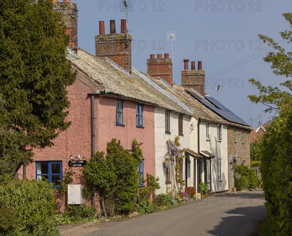 Row of pretty historic cottages, East Lane, Bawdsey, Suffolk, England, UK
