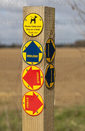 Close up of wooden post with byway and bridleway direction pointer signs, Sutton, Suffolk, England, Uk