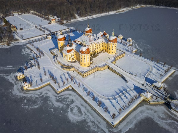 Moritzburg Castle on the castle island surrounded by the frozen castle pond, Moritzburg, Saxony, Germany, Europe