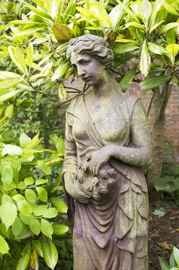 Classical style female cast iron statue figure statue, The Walled garden plant nursery, Benhall, Suffolk, England, UK