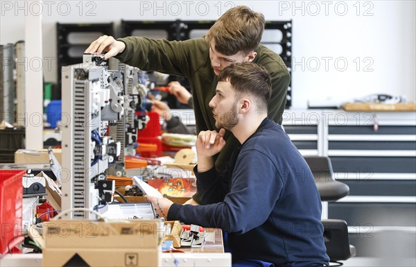 An electronics apprentice assembles a motor protection relay at a Deutsche Bahn training centre, Berlin, 07/02/2024