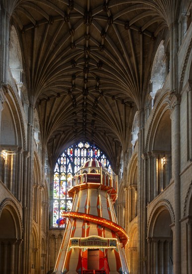 Traditional helter skelter fairground ride inside cathedral church at Norwich, Norfolk, England, UK, August 2019