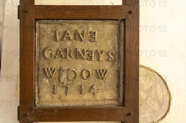 Historic village parish church at Kenton, Suffolk, England, UK lead roof tile mason's panel dated 1714