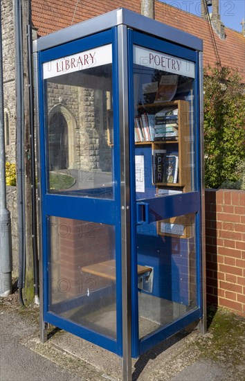 Old telephone booth box used as a poetry library, Tisbury, Wiltshire, England, UK