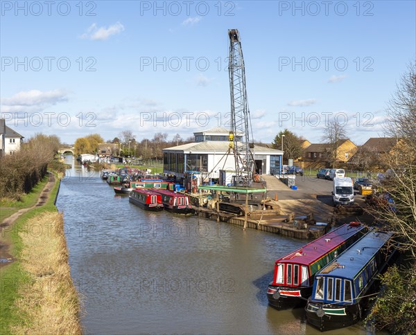 Narrowboats and crane, ABC Leisure Group boatyard, Kennet and Avon canal, Hilperton marina, Trowbridge, Wiltshire, England, UK