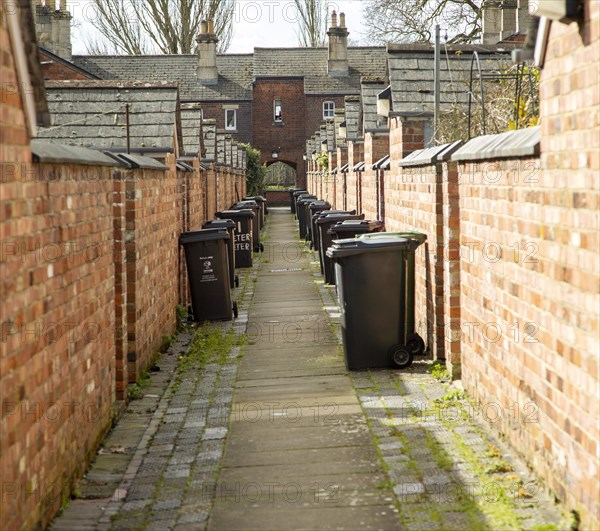 Rubbish refuse bins in back alley of terraced houses in Railway Village, Swindon, Wiltshire, England, UK