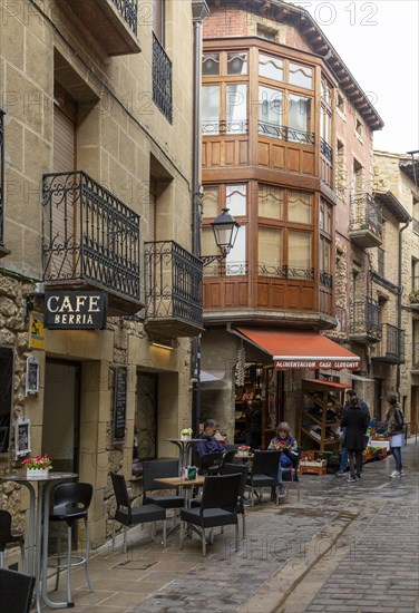 People in street on a wet day in village of Laguardia, Alava, Basque Country, northern Spain