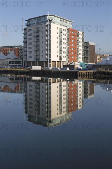 Modern apartments architecture reflected in water Ipswich Wet Dock waterside redevelopment, Ipswich, Suffolk, England, Uk