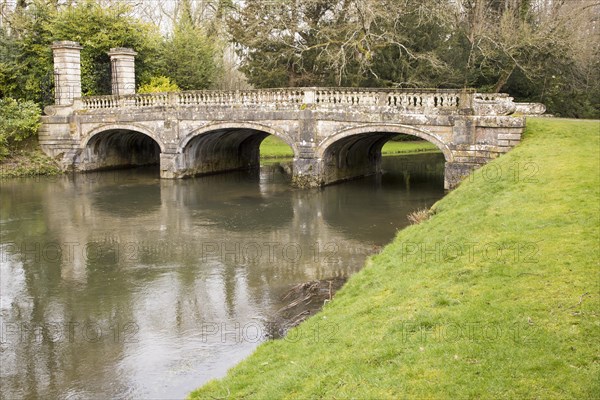 Historic ornamental stone bridge over River Avon in Amesbury Abbey Park, Amesbury, Wiltshire, England, UK