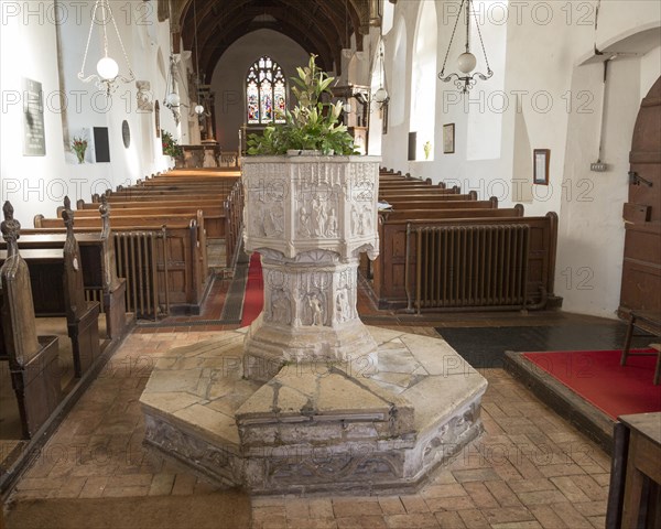 Village parish church baptismal font circa 15th century, Saint John the Baptist, Badingham, Suffolk, England, UK