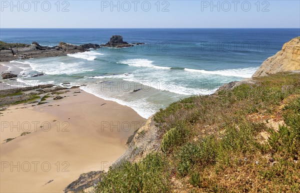 Sandy Carvalhal beach in bay between rocky headlands at Parque Natural do Sudoeste Alentejano e Costa Vicentina, Costa Vicentina natural park, near Brejao, south west Alentejo, Alentejo Littoral, Portugal, Southern Europe, Europe