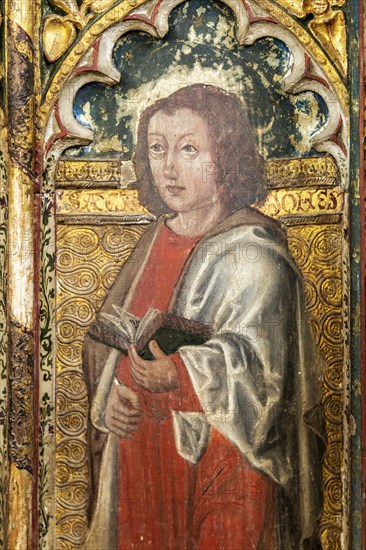Medieval paintings of saints on rood screen inside church of Saint Andrew, Bramfield, Suffolk, England, UK, Saint John