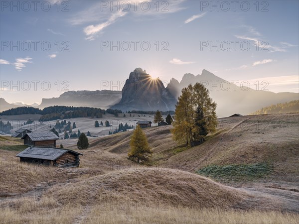 Autumn on the Seiser Alm, Alpine huts with Plattkofel and Langkofel, sunrise, sun star, frost, Dolomites, South Tyrol