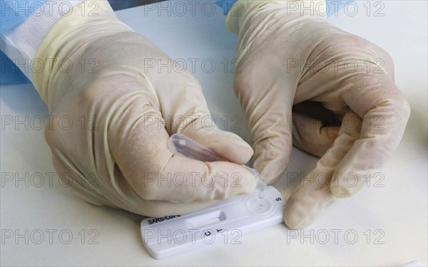 Employee analyses a sample in a Corona rapid test centre, Eberswalde, 17.03.2021