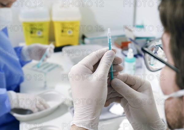 Syringes are filled with the Covid19 Biontech Pfizer vaccine Comirnaty in a vaccination centre by soldiers of the German Armed Forces, Schoenefeld, 26.02.2021