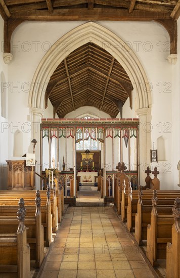 Village parish church Parham, Suffolk, England, UK view of chancel arch rood screen and east window