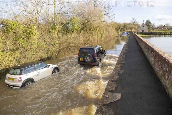 Land Rover Discovery Td5 vehicle driving through flood water at Kellaways, Wiltshire, England, UK 24/12/20