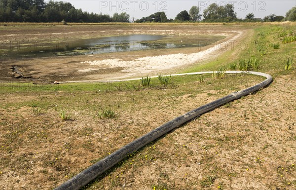 27 July 2018 Low water level in farm irrigation lake after long summer drought, Sutton, Suffolk England, UK
