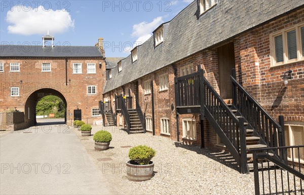 Historic industrial maltings buildings converted to housing, Snape Maltings, Suffolk, England, UK