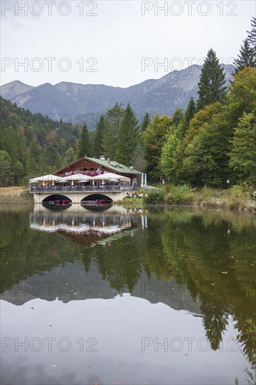 Pflegersee with inn under a cloudy sky, Garmisch-Partenkirchen, Werdenfelser Land, Upper Bavaria, Bavaria, Germany, Europe