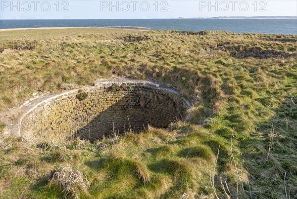 Top of old lime kilns on Holy Island, Northumberland, England, UK view south of coastline