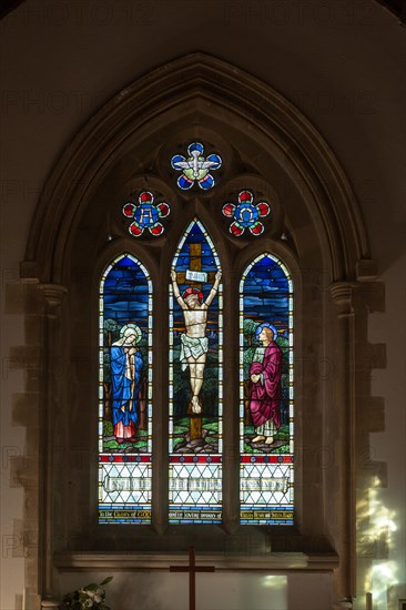 Stained glass window of Jesus Christ Crucifixion, Hullavington church, Wiltshire, England, UK c 1925 William Glasby