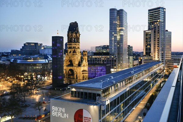 View of Breitscheidplatz in the evening with the Bikini building, the Kaiser Wilhelm Memorial Church, the Walldorf Astoria Hotel and the Upper West skyscraper, Berlin, 27.04.2021