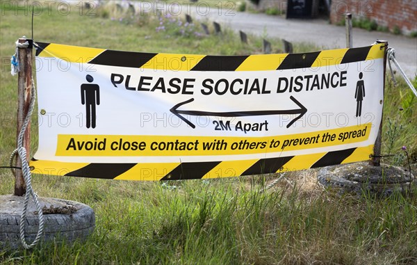 Please Social Distance 2 metres apart banner Avoid close contact with others to prevent the spread, UK