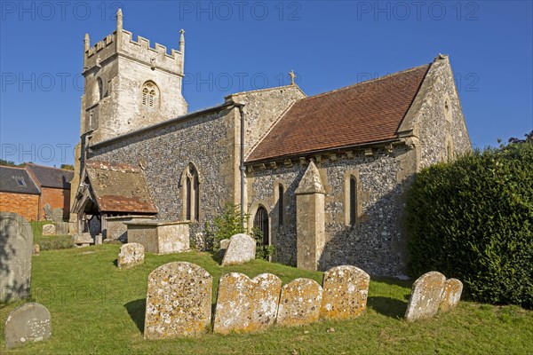 Village parish church of Saint Nicholas, Fyfield, Wiltshire, England, UK weathered gravestones in churchyard