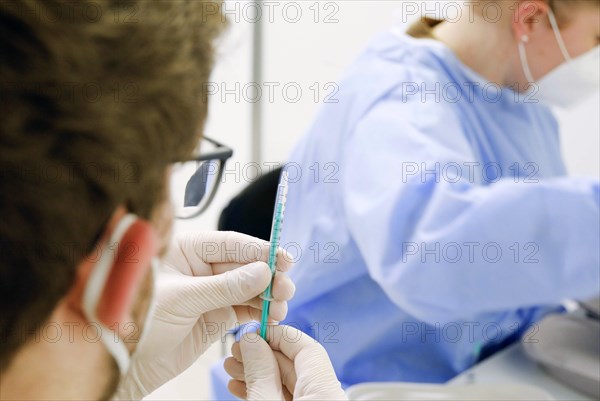 Syringes are filled with the Covid19 Biontech Pfizer vaccine Comirnaty in a vaccination centre by soldiers of the German Armed Forces, Schoenefeld, 26.02.2021