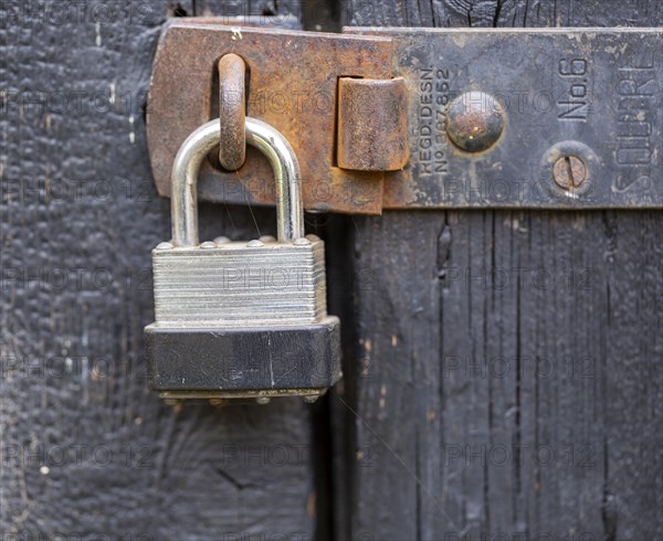 Macro close up of padlock securing door shut securely