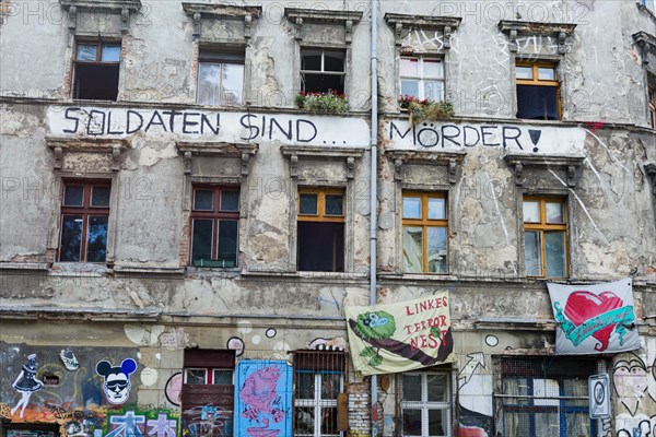 Covered wall with graffiti and political messages, left-wing political, politics, house, facade, house facade, texture, background, colourful, dilapidated, scene, alternative, urban, art, dirty, decoration, Berlin, Germany, Europe